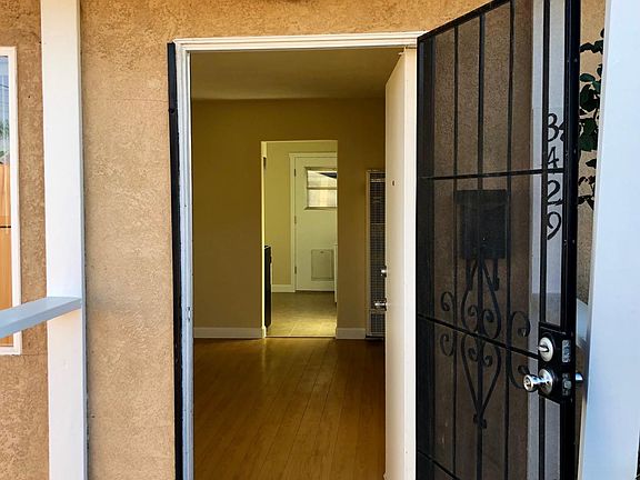 Looking through front door to living room, through kitchen. Back door in the distance