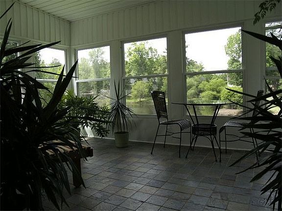 Florida room with slate tiles and water view