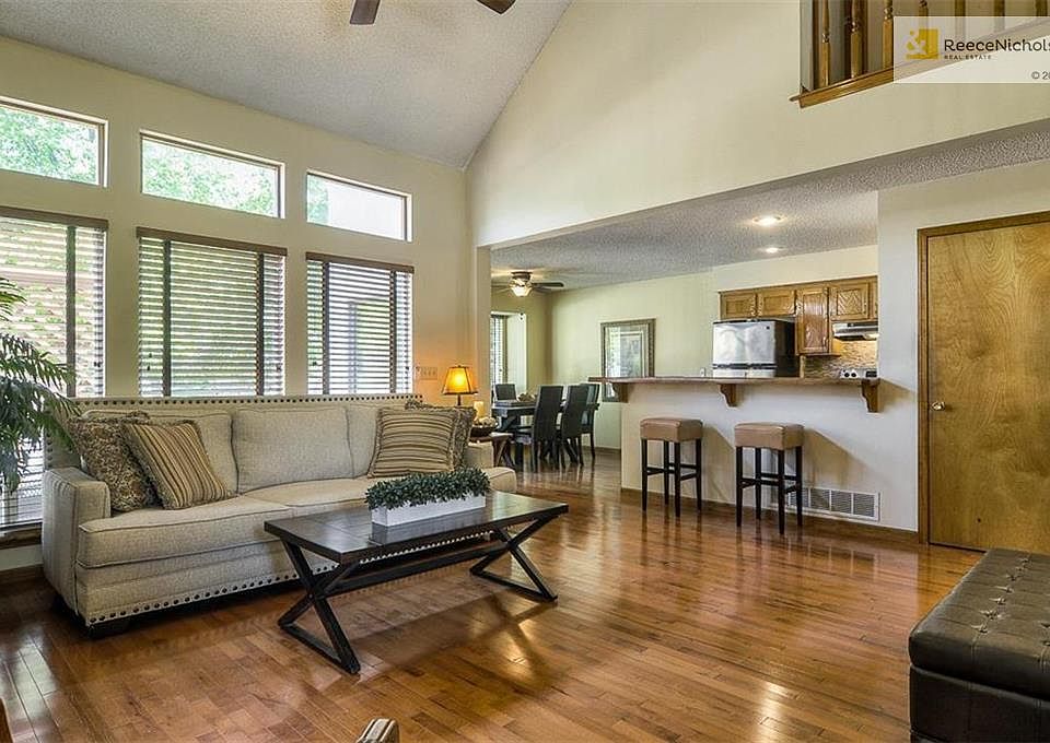 Spacious great room with high ceilings with custom blinds on main level.