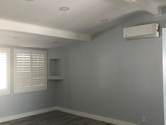 Living room is clean and recently painted with new floor tiles. New AC unit.