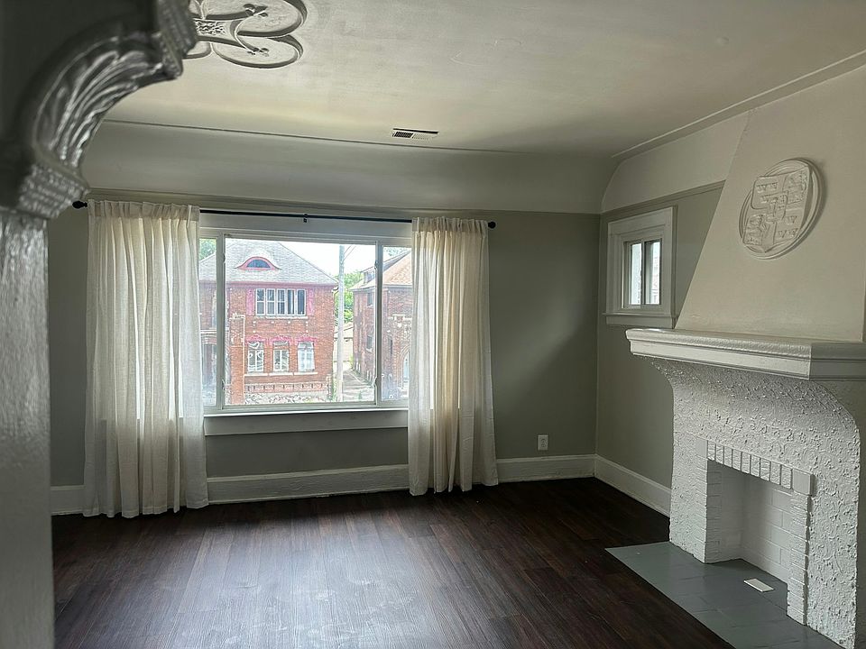 Living room view to front of the house. Staircase and entry way are to the left, as well as a coat closet and the front balcony