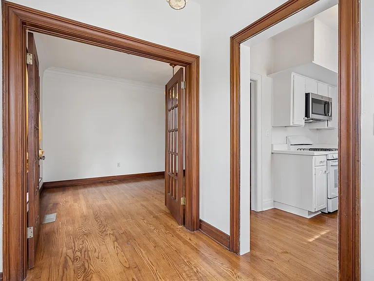 Dining nook looking towards formal dining room through double doors.