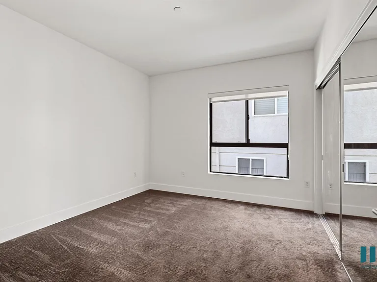 Bedroom with Large-Size Mirrored Closet and Windows