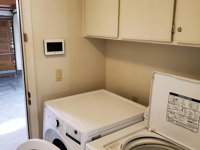 washroom/laundry with washer, dryer, and entry looking towards garage.