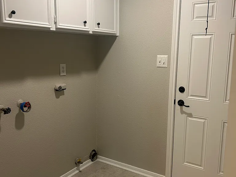 The utility room leads to the garage. It is large enough for an another refrigerator, freezer or extra cabintry.