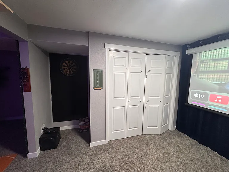 extra closet for storage or clothes. and dart board!