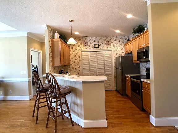 Kitchen breakfast bar with corian counters, and all brand new appliances
