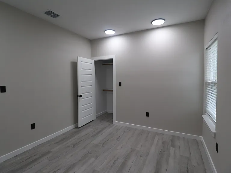 Bedroom 1 of 4 featuring modern flooring, recessed lighting, natural light, and a spacious closet.