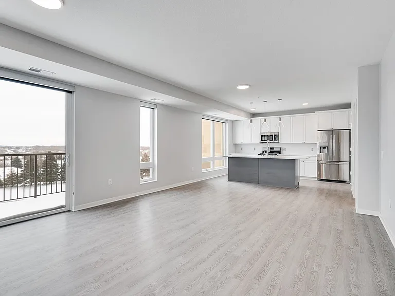 Open-concept living with large windows and a private balcony, perfect for town home living.