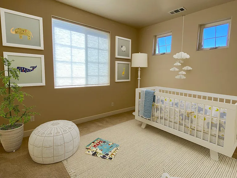 Bright secondary bedroom with large windows and generous closet space.
