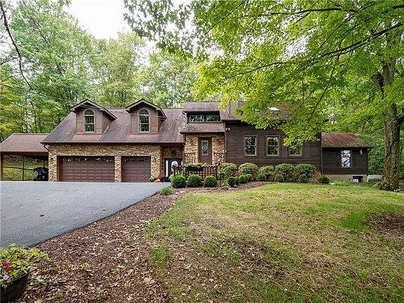 This custom home is situated on nearly 3 private acres in the heart of Cranberry.
