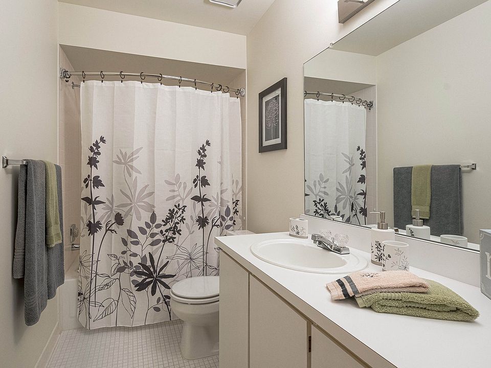 Modern bathroom with vanity mirror at Eastwood Village Apartments in Clinton Township, MI