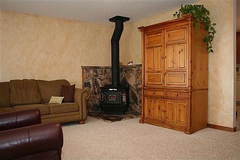Lovely livingroom w/faux finished walls and cozy woodstove