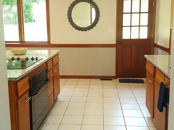 Kitchen includes oven, cooktop, dishwasher, tile flooring 