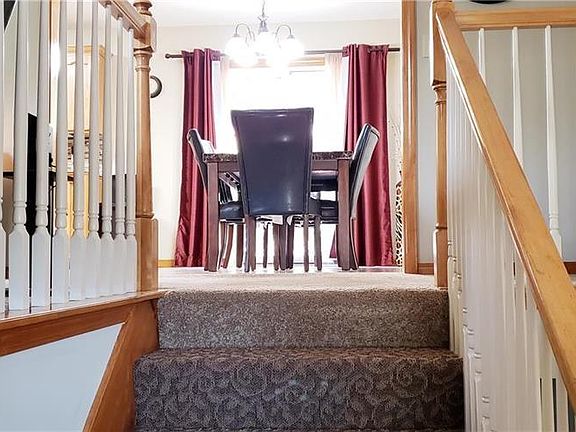Designer carpet on the stairs and hardwood in the entry.