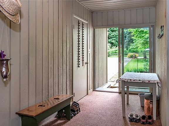 Mudroom/Enclosed Breezeway Provides Wonderful Space for Shoes and Gear!