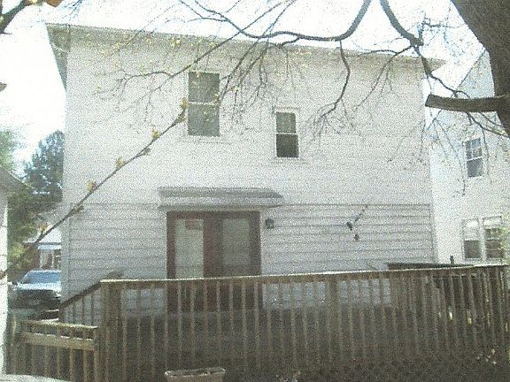 back of house with deck