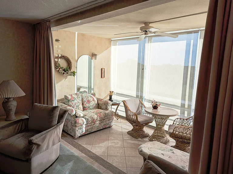 Custom drapery spans across living room to lanai.