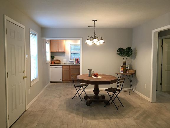 View from front door entry. (The door to left of the picture is the alternative side door). The living/dining room and opening into the kitchen. To the right side of this picture is the hallway leading to front and middle bedrooms. The home's floor is til