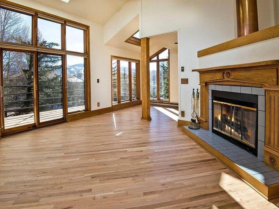 Bright and sunny family room with fireplace and views of Beaver Creek ski area