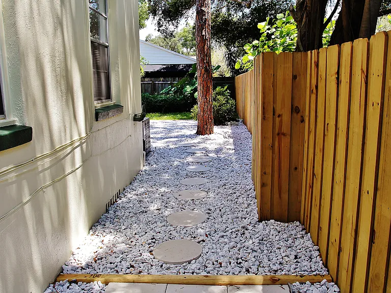 Side Walkway To Garbage and Recycle Bins.