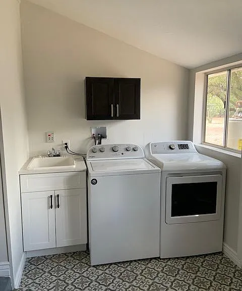 Separate laundry room off kitchen. On-demand hot water heater on the outside allows room for a new sink. New washer and energy efficient gas dryer.
