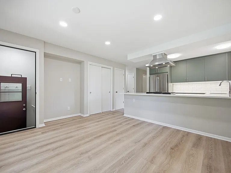 Dining room (or potential family / TV room) with back door (on left) to back patio, screened-in porch and lower and upper back yard areas. Built-in kitchen pantry and large closet