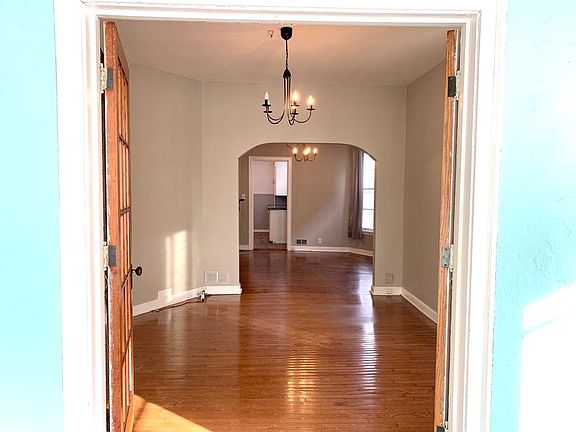 Looking from the 3 season front porch through the Living Room & Dining Room. Beautiful french door separate the porch from the Living room giving tons of natural lighting.