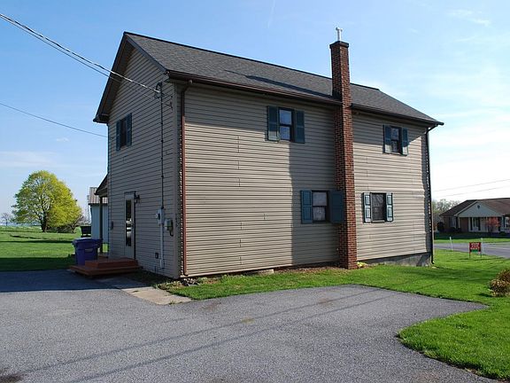 View of home from road - Ample off-street parking in paved driveway. (1-car Indoor/Garage space is available for an additional +$50/month.)