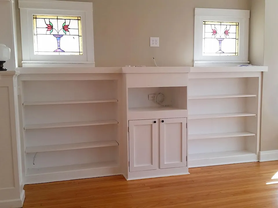 Built in entertainment center bookcase with stained glass windows