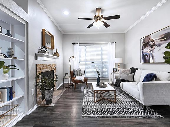 Living Area Featuring Stone Fireplace Surround and Decorative Bookcase