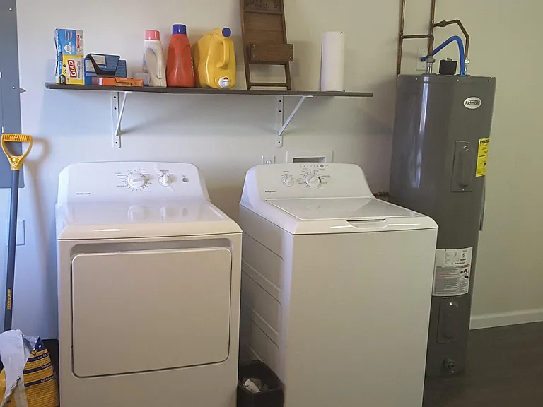 Washer in dryer in laundry room shared by one other apartment.