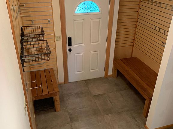 Remodeled entryway with plenty of hooks for all your jackets, skis, and room under the bench for your boots. With warm heated floors too!
