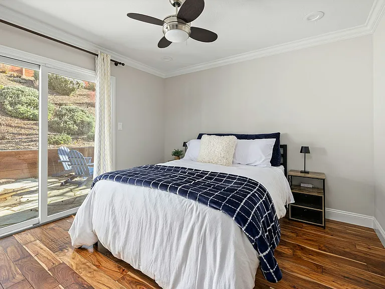 Peaceful retreat with outdoor access enjoy restful nights and sunny mornings in this bright bedroom with sliding doors that lead straight to the patio.
