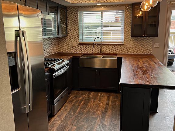 Modern Back Splash with Accent Trim Around Recess Lighting and Ash Butcher Block Window Sill
