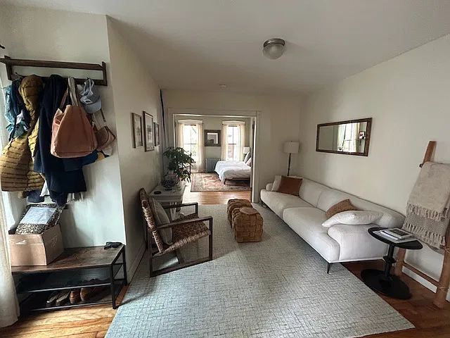 view of living room (+ second bedroom) from the front door.