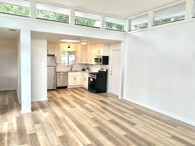 Perfect for entertaining! The light-filled central great room opens to bright modern new kitchen and a spacious balcony.