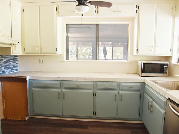 Kitchen with new counter tops. Stove will be in place by rental date. Also includes dishwasher, full sized fridge, and microwave.