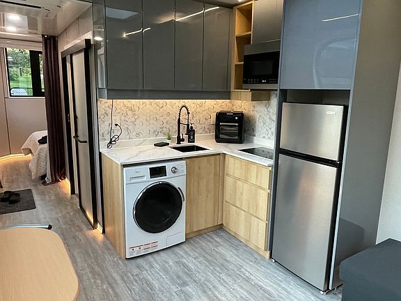 Kitchen with air fryer and dual stovetop. Full washer/dryer in one.