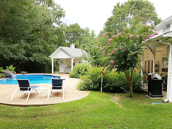 View of pool and pool house