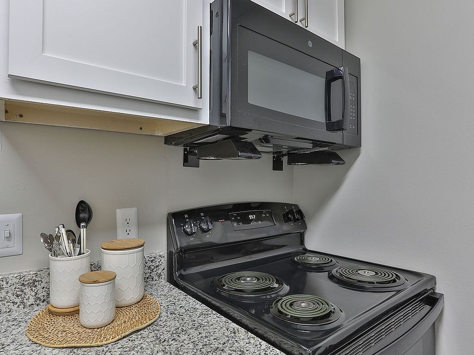Kitchen with granite counters and black appliances