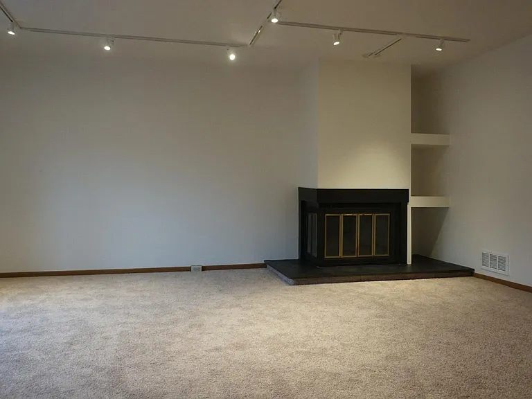 Living room with wood fireplace and bay window