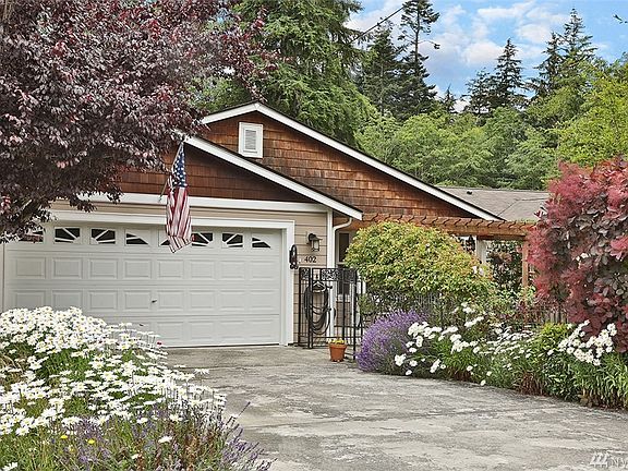 Lovely gardens surround the home and it is completely fenced ... front and back!