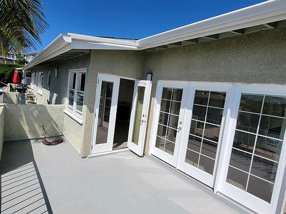 Double sets of French doors from large front deck into kitchen and living room. Great for entertaining and opening up the space to breezes and the beautiful view.