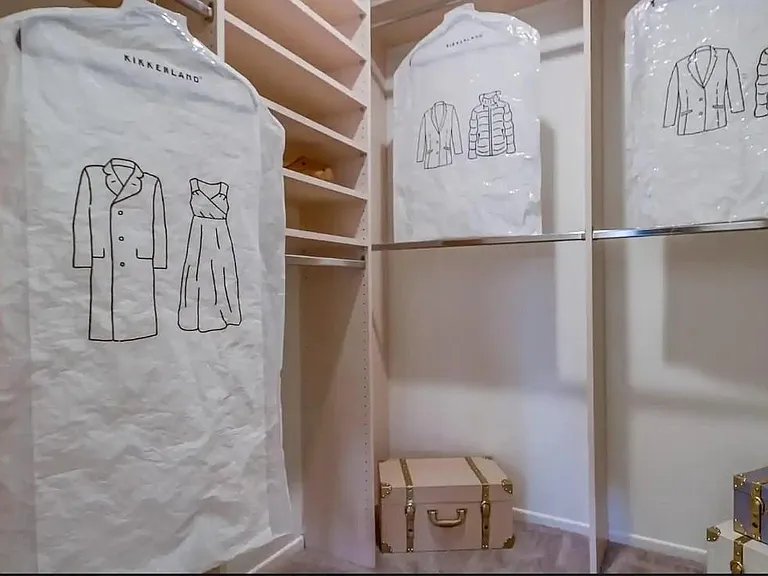 Primary bedroom walk-in closet with shelving and plenty of hanging space