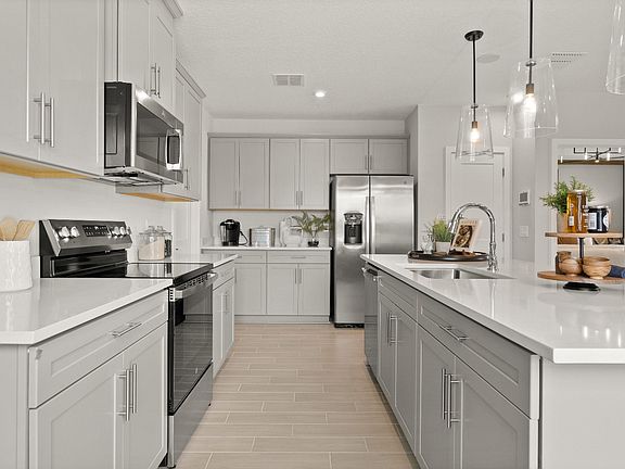 Open Concept Kitchen with spacious island at the Jupiter Model at Grasslands West in Lakeland, FL