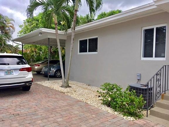 Paved driveway, carport with utility storage for each unit