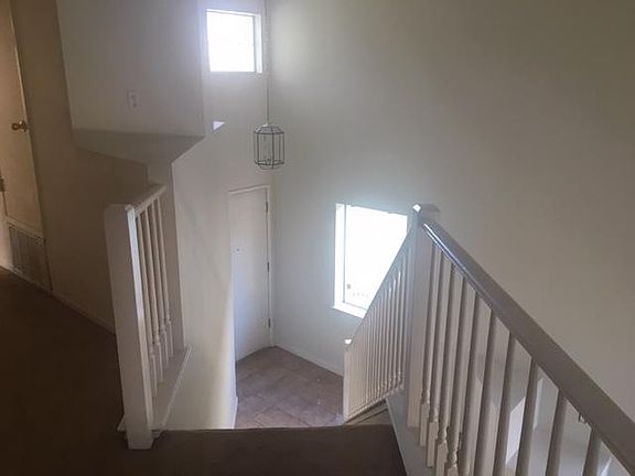 Entrance and stairs up high cathedral ceilings
