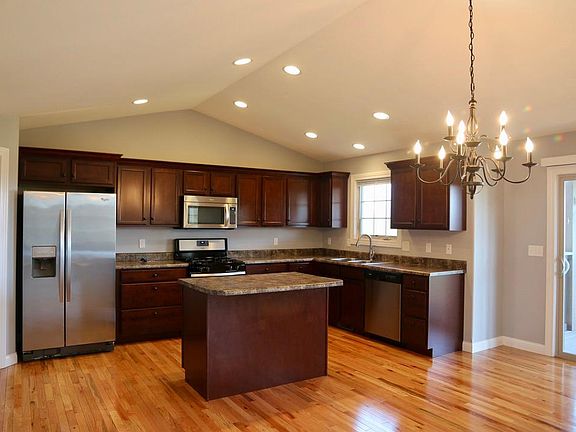 Kitchen includes: whirlpool appliances and garbage disposable. Breakfast bar island with additional storage.
