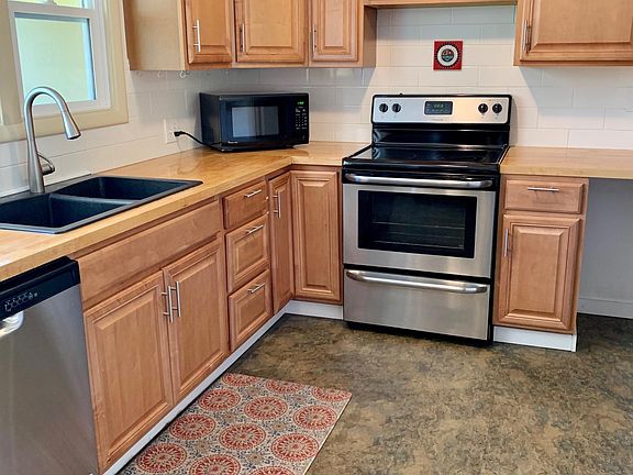 Kitchen with stainless steel appliances and fridge (not shown).